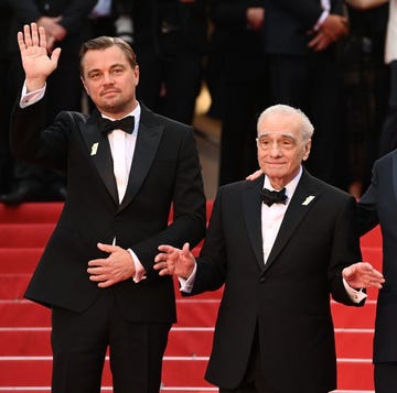 Leonardo DiCaprio, Martin Scorsese, and Robert De Niro at the 76th Cannes Film Festival in May 2023 leonardo dicaprio, martin scorsese, and robert de niro stand on a red carpet, all three men are wearing black suits with white shirts and black ties, dicaprio is waving with one hand, scorsese has both hands slightly extended in front of him, and de niro has one hand on scorseses shoulder