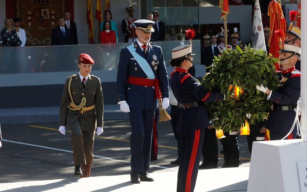 a group of men in military uniforms holding flowers