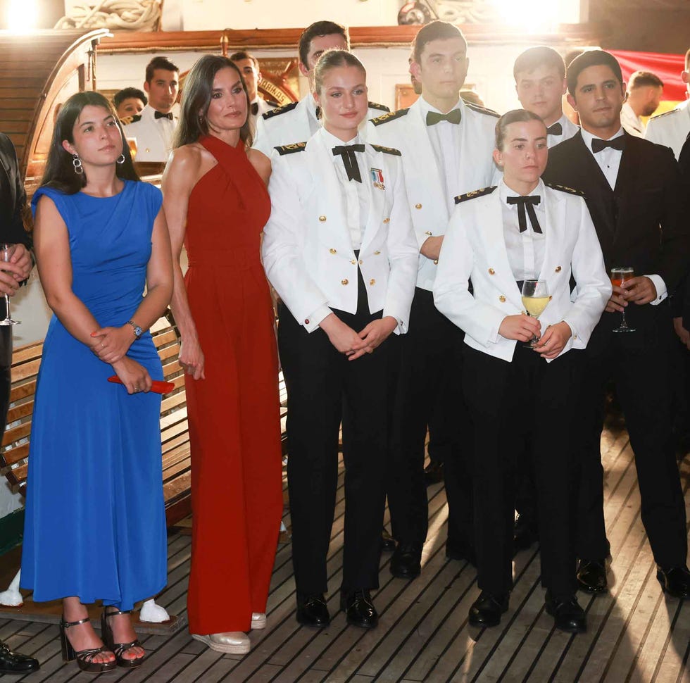 group of people posing together in formal attire at a social event