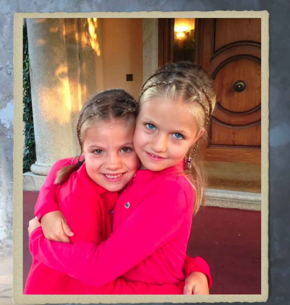 two children embracing in a warm setting