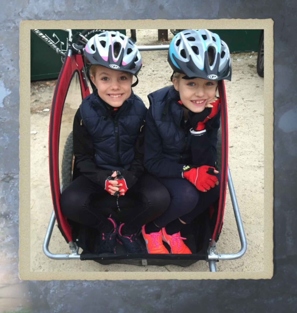 two individuals seated in a bike cart