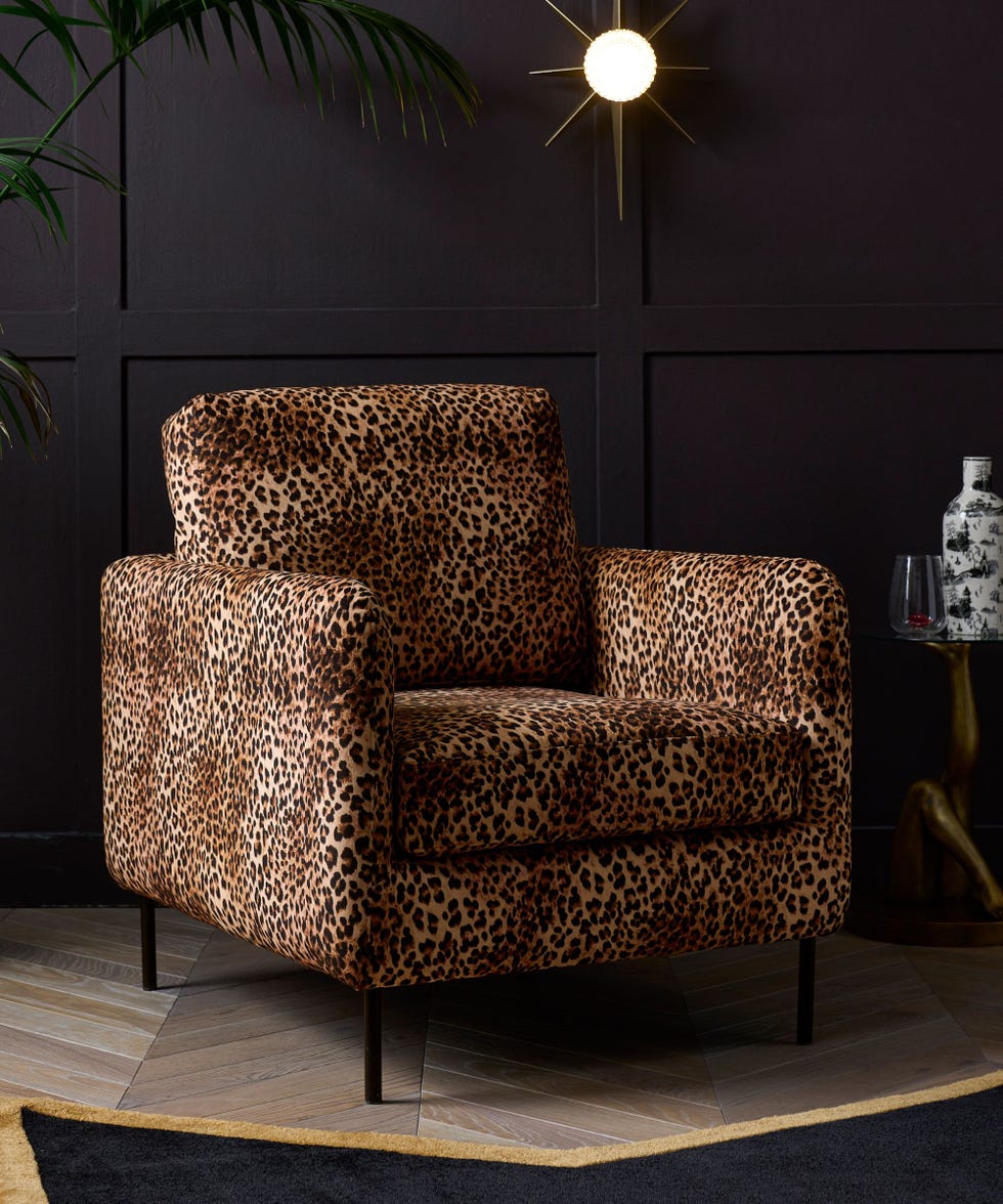 leopard print armchair in black panelled room