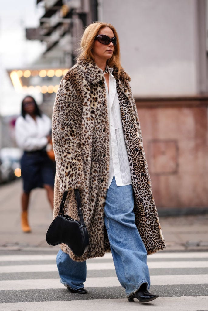 copenhagen, denmark january 31 a guest wears sunglasses, a brown leopard print fluffy long coat, a white oversized shirt, blue fl, outside the garment, during the copenhagen fashion week aw24 on january 31, 2024 in copenhagen, denmark photo by edward berthelotgetty images