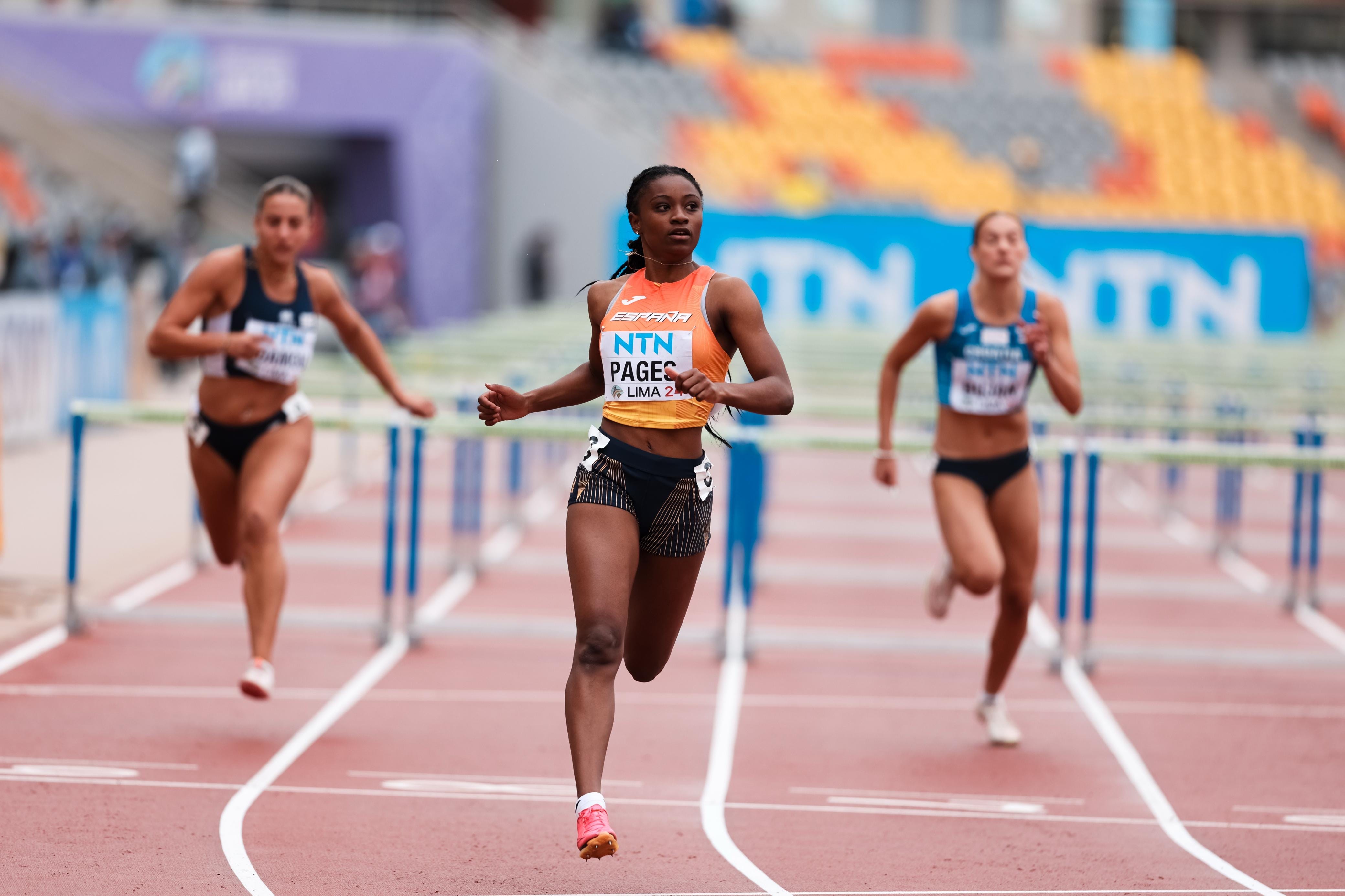athletes participating in a hurdle race on a track