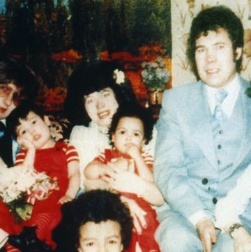 a woman, a man, and 10 children pose for a photo
