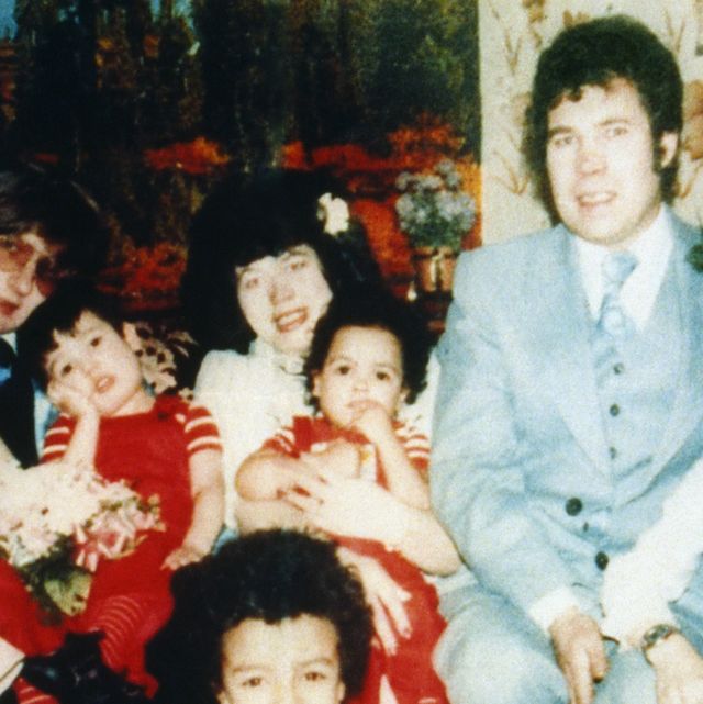 a woman, a man, and 10 children pose for a photo