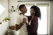 lesbian couple dancing in living room