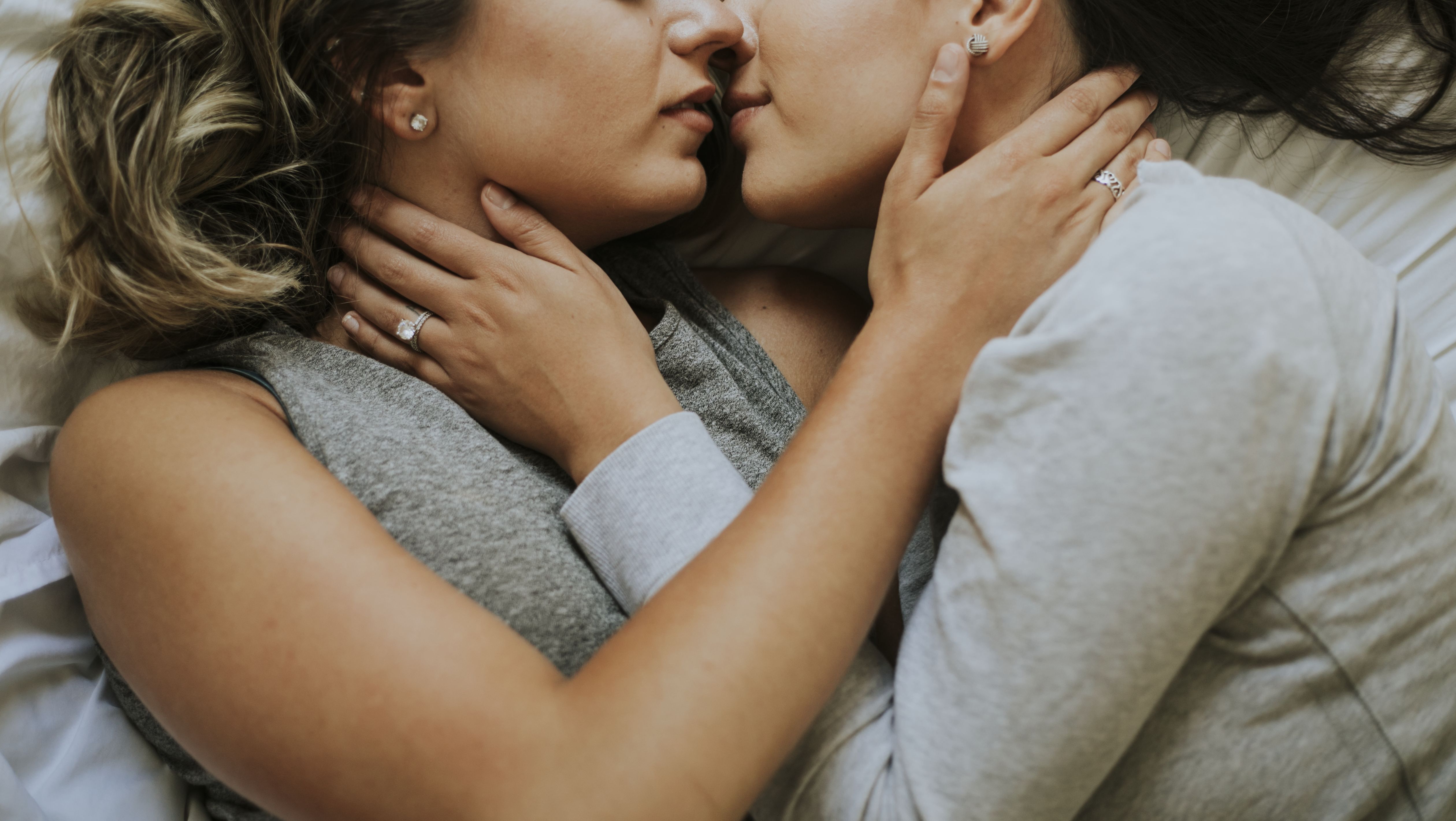 lesbian couple kissing in the morning
