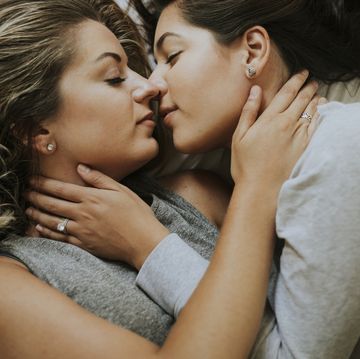 lesbian couple kissing in the morning