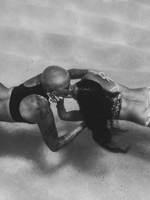 two women kissing underwater