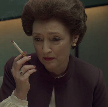 a person holding a cigarette in a professional setting a person holding a cigarette in a professional setting