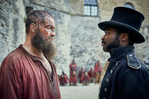 Jean Valjean (Dominic West) stares down Javert (David Oyelowo) in Les Misérables.