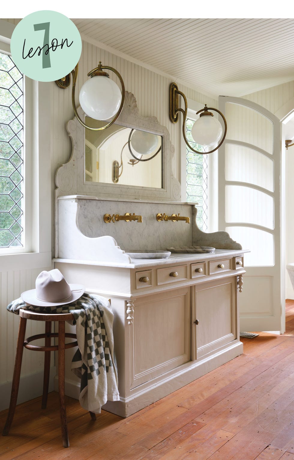 vintage inspired wash station with dual sinks and elegant lighting features