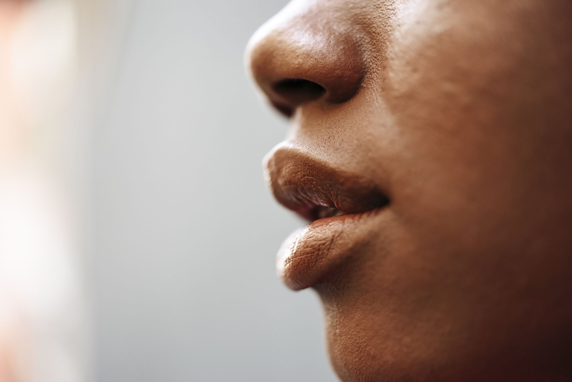 nose, lips and cheek of young woman, close up