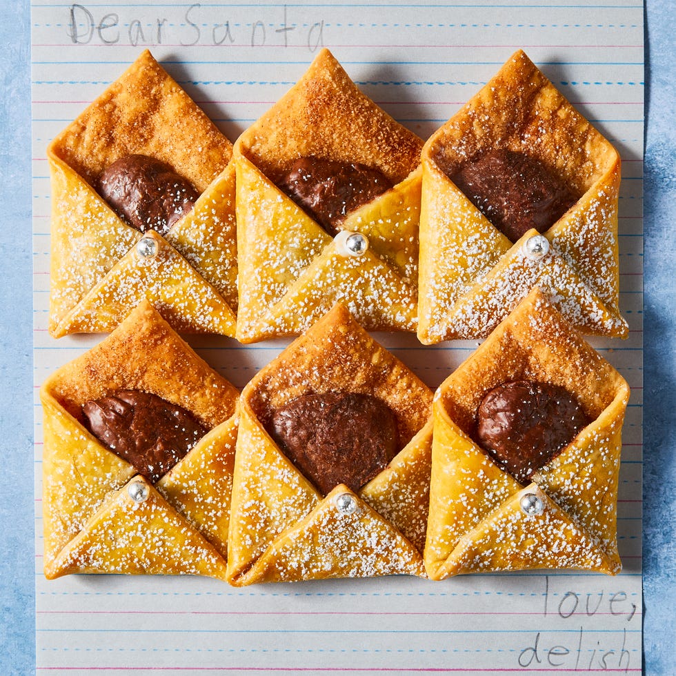 letter shaped pastries filled with chocolate and cinnamon sugar on a plate with milk