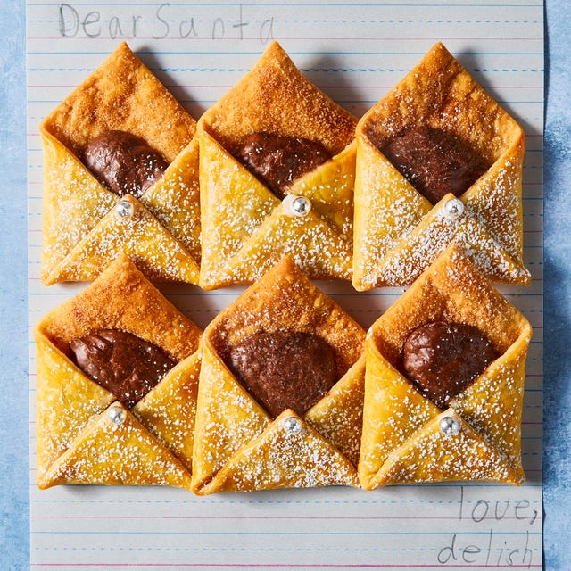 Letters To Santa letter shaped pastries filled with chocolate and cinnamon sugar on a plate with milk