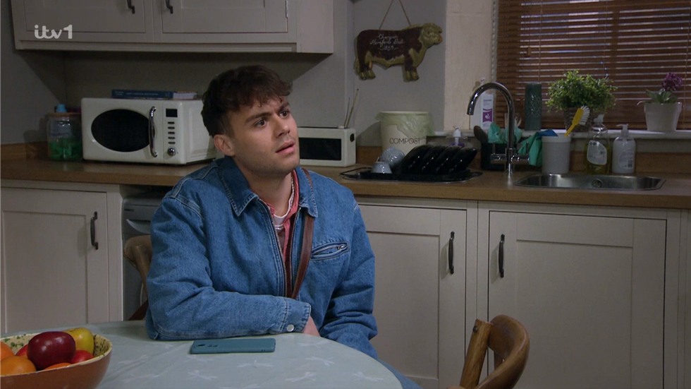 lewis barton looking stunned on emmerdale