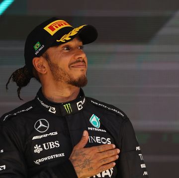 formula 1 driver lewis hamilton smiles and places his hand on his heart during the celebrations after a grand prix