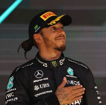 formula 1 driver lewis hamilton smiles and places his hand on his heart during the celebrations after a grand prix