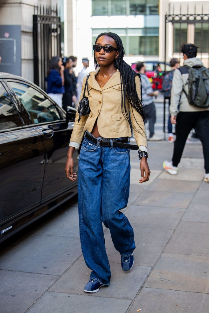 london, england september 15 a guest wears beige jacket, denim jeans outside jw anderson during london fashion week september 2024 on september 15, 2024 in london, england photo by christian vieriggetty images