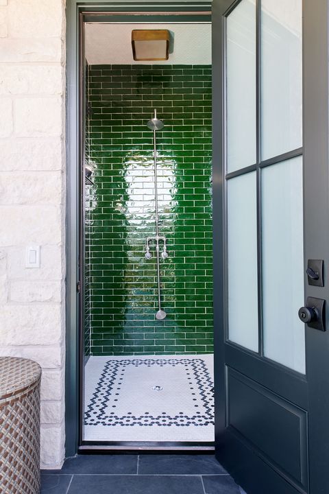 walk in bathroom with green shower tile