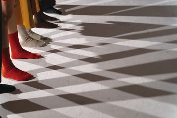 a pair of feet in red socks on a checkered floor