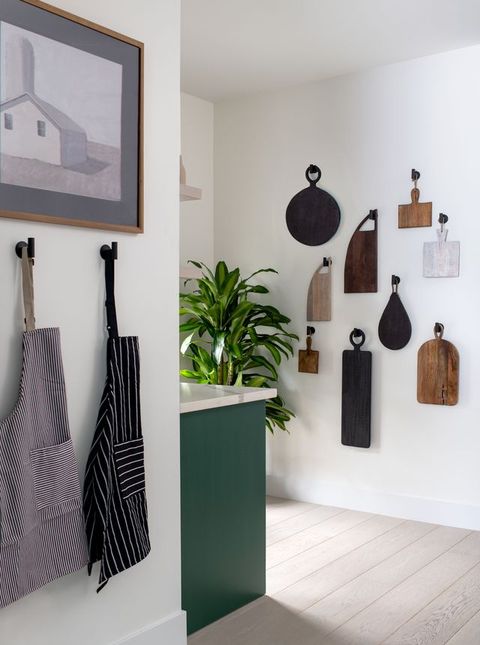 cutting boards on hooks on a white wall