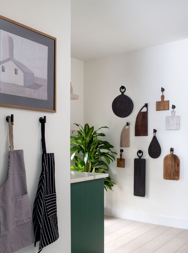 cutting board hanging on the wall in kitchen designed by linda hayslett