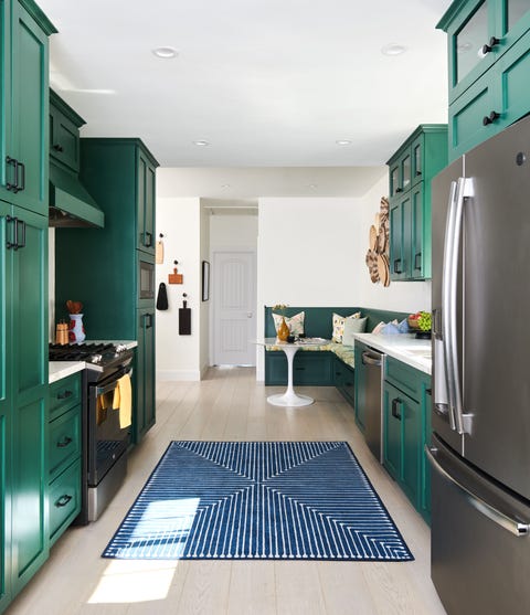 Kitchen with green cabinets designed by Linda Hayslett