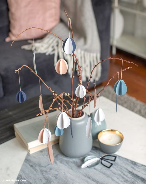pussy willow branches in a vase decorated with three dimensional eggs in blue, white and pink
