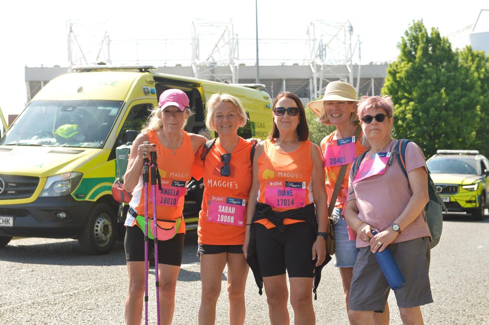 group of individuals in bright orange shirts participating in a charity event