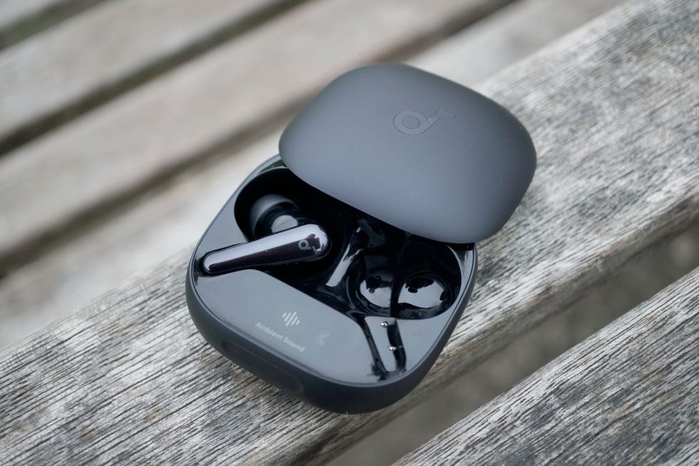 soundcore liberty 4 pro wireless earbuds in a charging case on a wooden surface