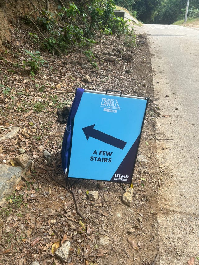 a blue sign on the side of a road