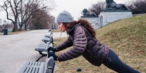 vrouw doet oefeningen op een bankje in het park