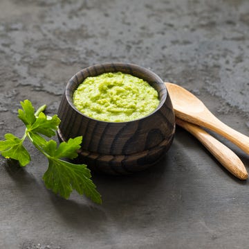 light appetizer, green horseradish wasabi in a wooden saucepan dark gray background rustic style