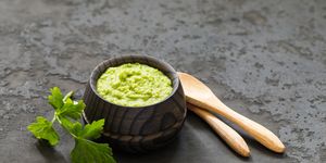 light appetizer, green horseradish wasabi in a wooden saucepan dark gray background rustic style