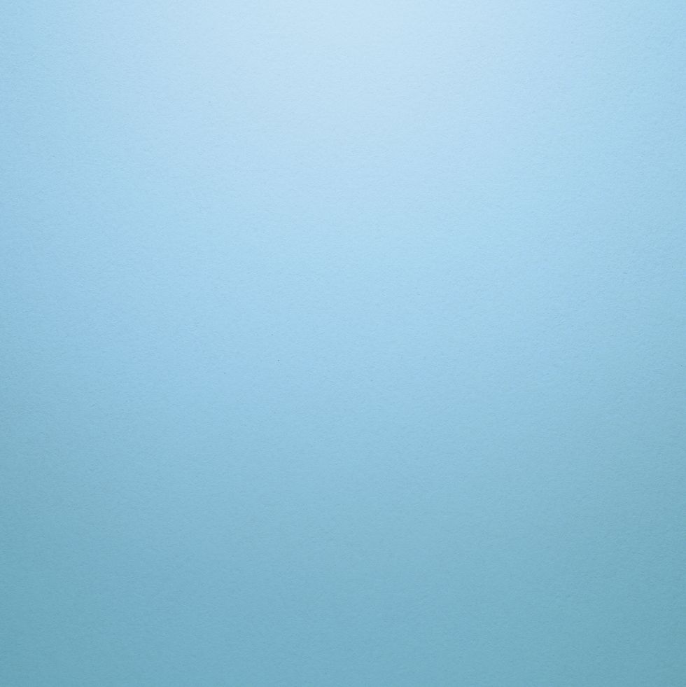 light blue or turquoise textured paper background with light effect copy space