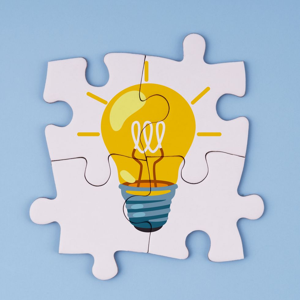 light bulb illustration on 4 piece jigsaw puzzle