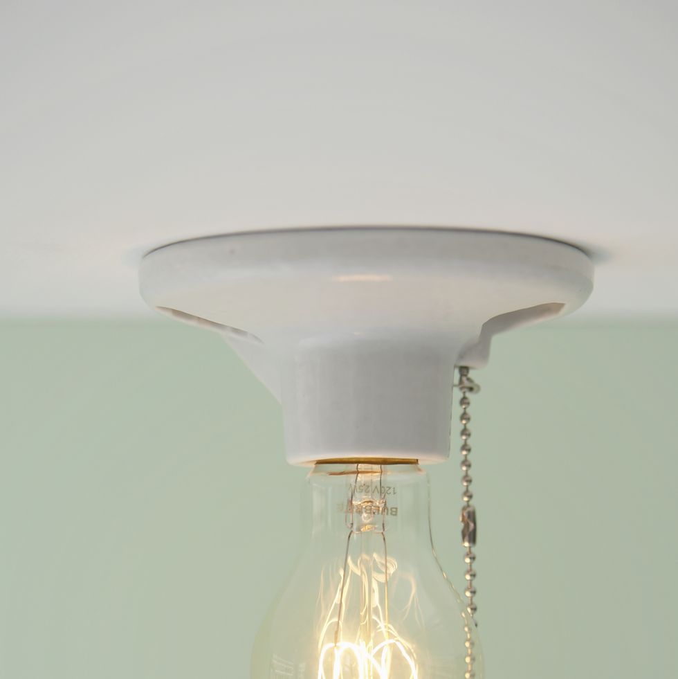 light bulb with pull cord hanging from ceiling