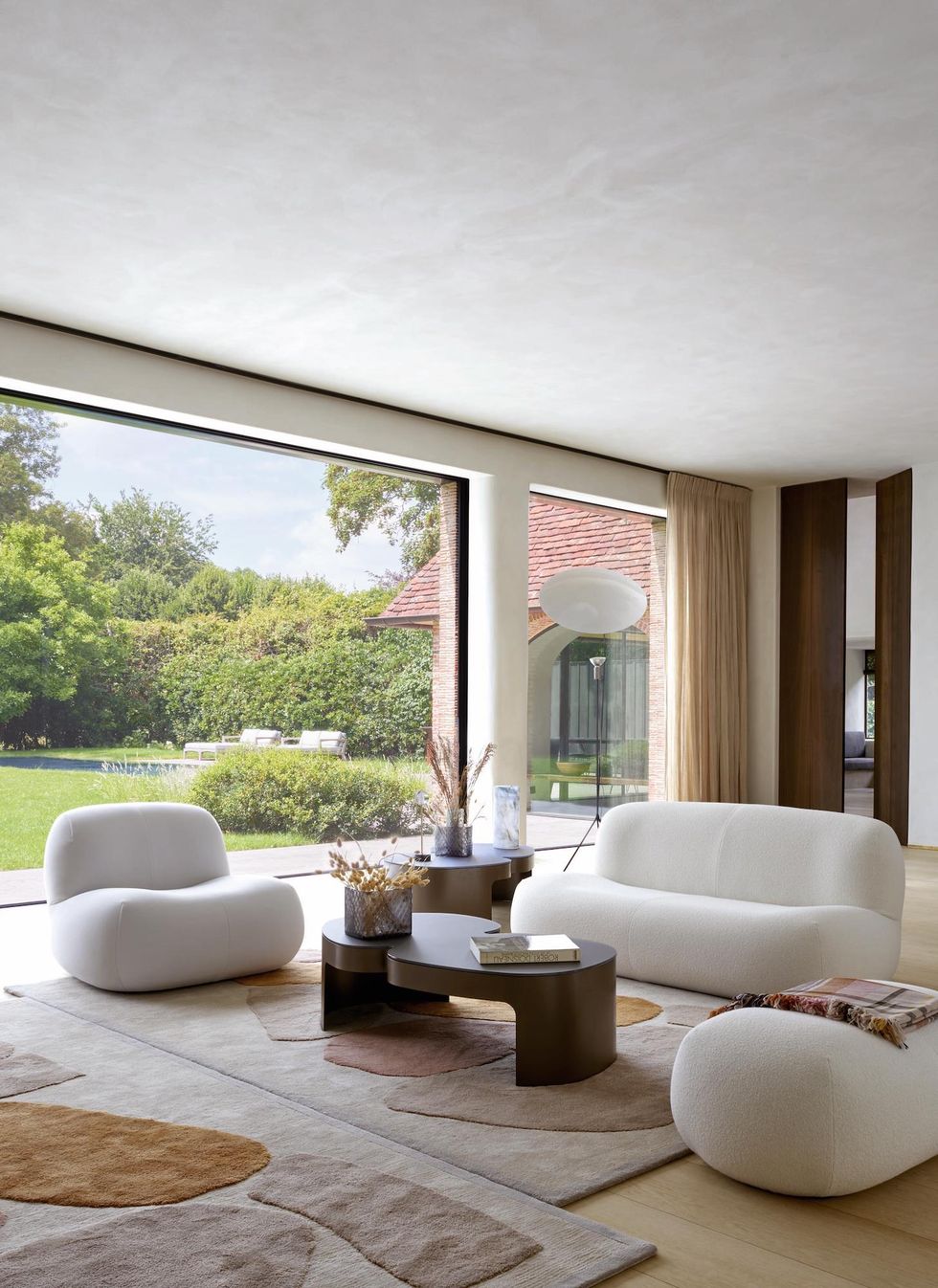 ligne roset living room with pukka sofa, armchair, footstool, table, rug