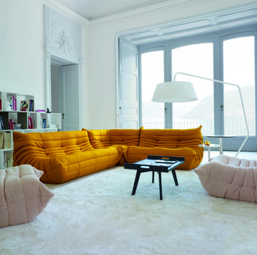 togo sofa design icon ligne roset yellow pink lamp white walls carpet