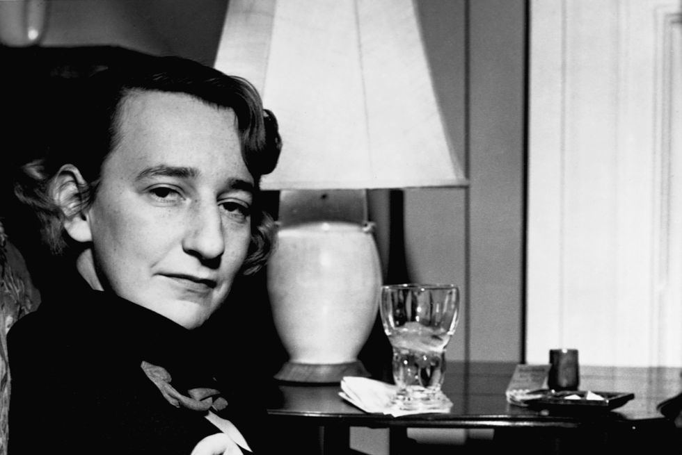 lillian hellman sits with arms folded
