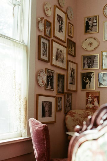 wall adorned with framed photographs and decorative plates