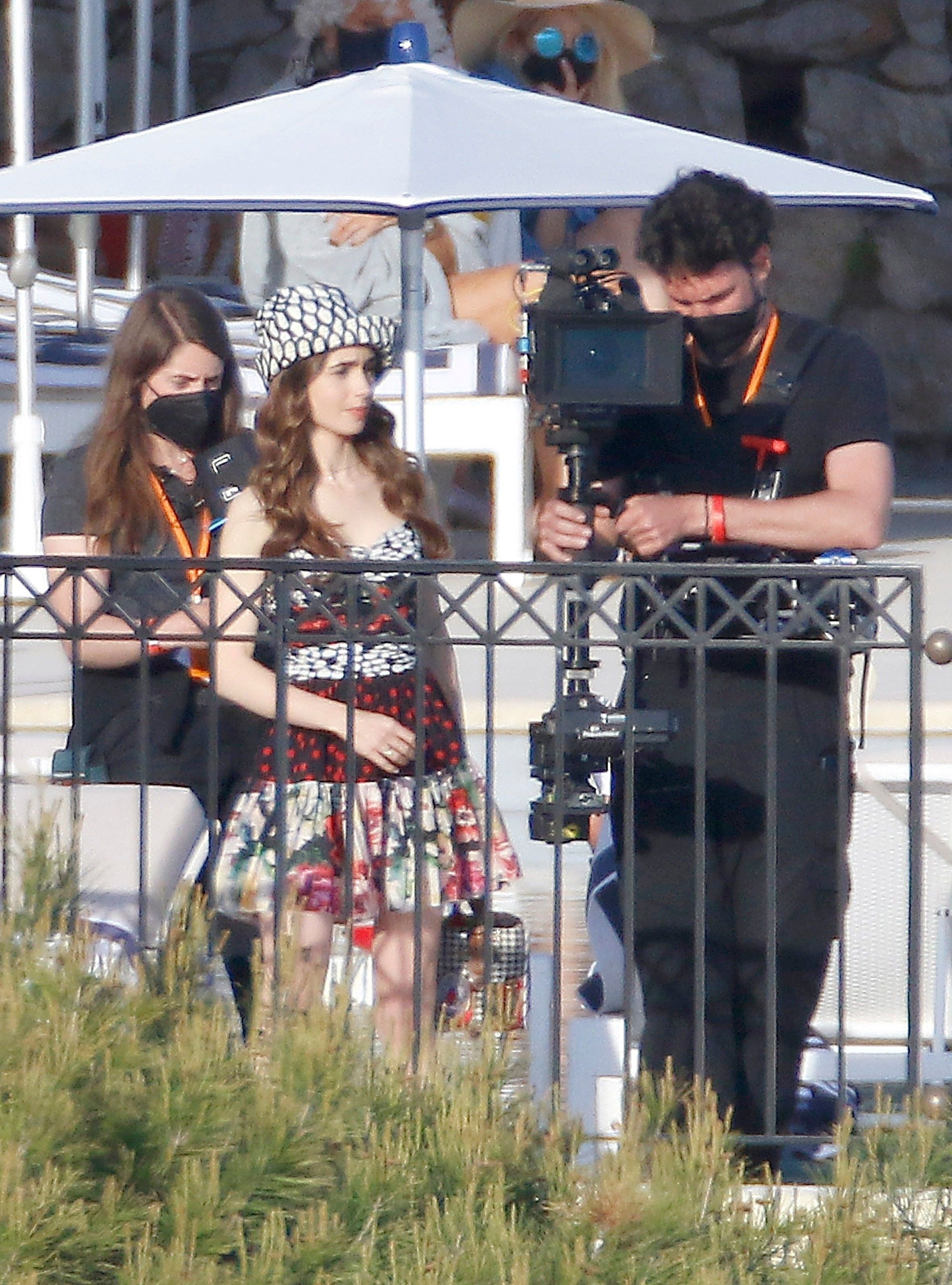Lily Collins rocks a plunging blue dress while filming series 2 of Emily In  Paris in France