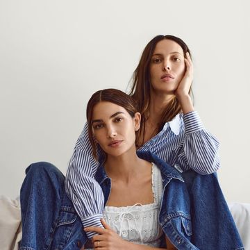 two women sitting on a bed