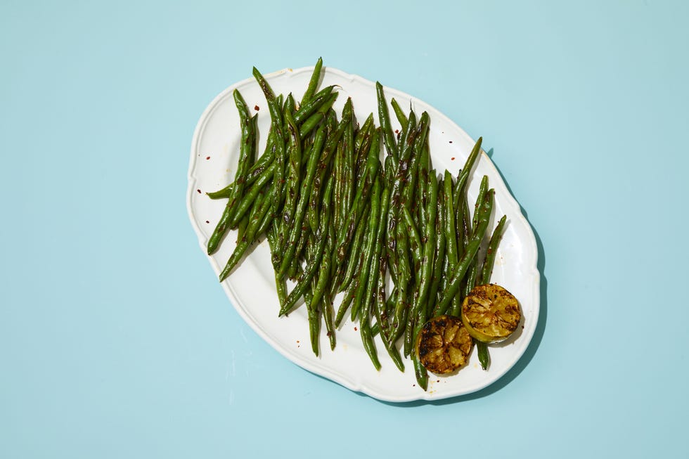 lime and aleppo pepper green beans on a white plate