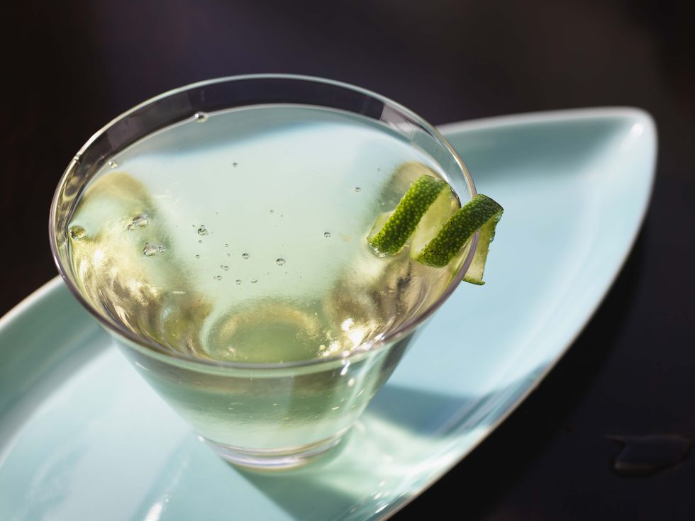 Lime twist garnish on alcoholic beverage
