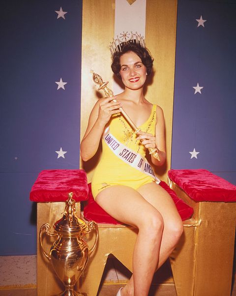 Linda Bement Posing with Miss Universe Trophy
