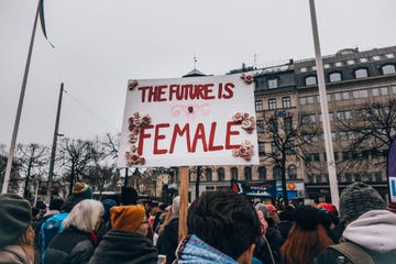 a crowd of people holding a sign