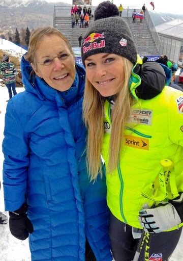 a couple of women posing for a picture in the snow